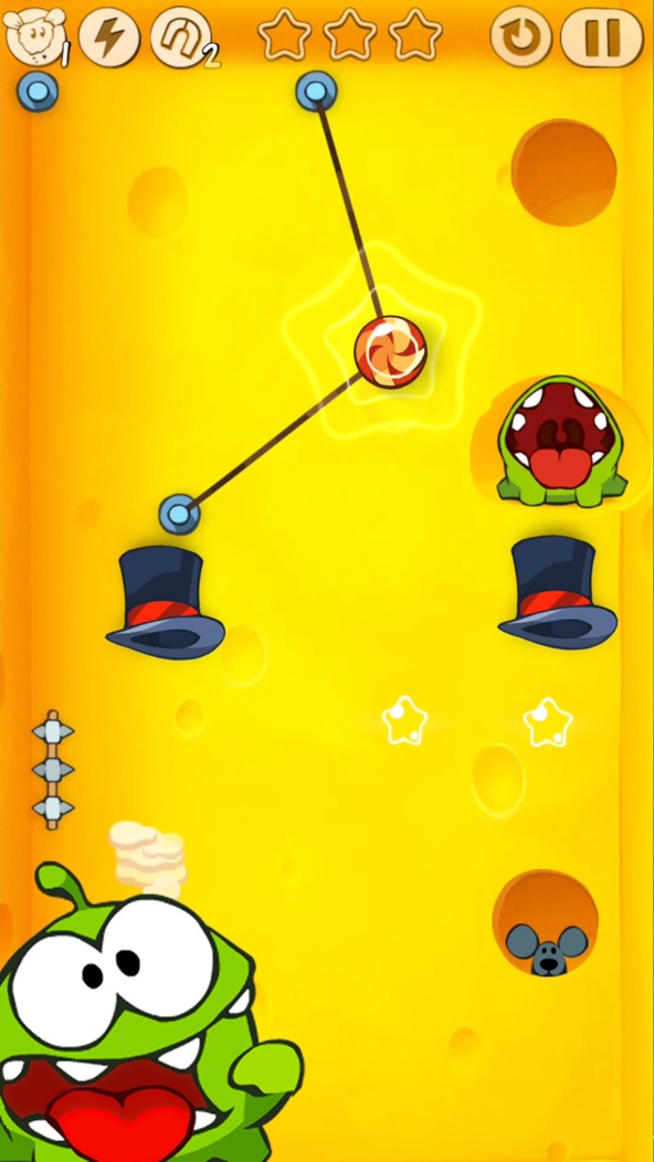 Cut the Rope gameplay screenshot — swiping a rope to drop candy to Om Nom