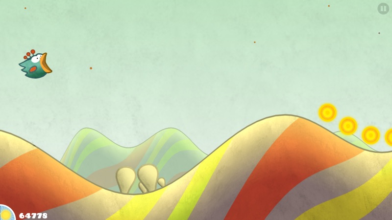 Tiny Wings gameplay screenshot — a small bird sliding down storybook hills